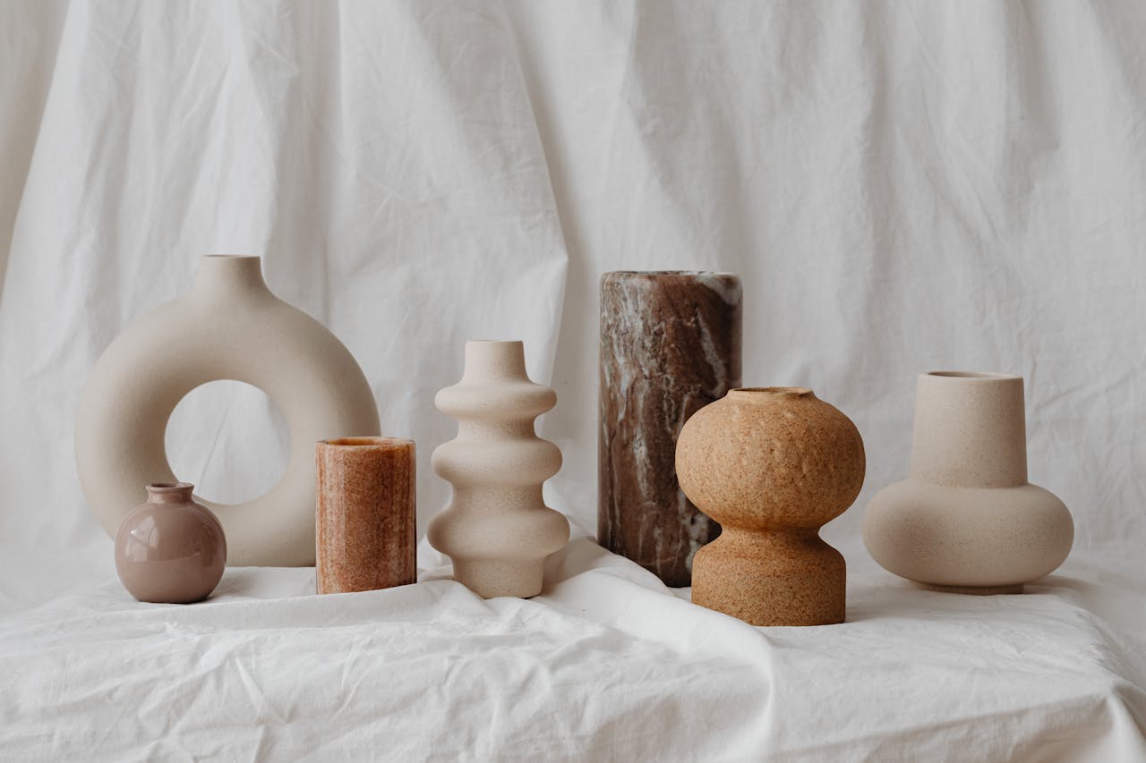 A curated assortment of unique ceramic vases in neutral tones, showcasing modern rustic design.